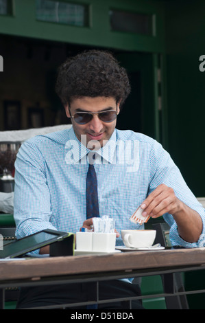 Businessman moving down on an escalator Stock Photo