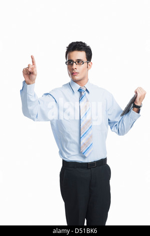 Businessman touching a visual screen and holding a digital tablet Stock Photo