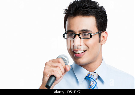 Businessman giving speech into a microphone Stock Photo