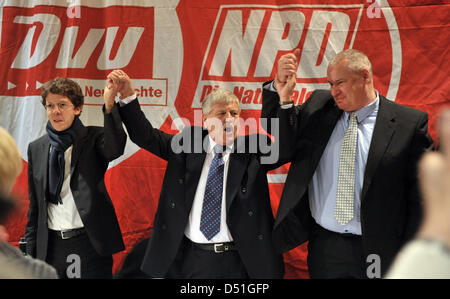 The party executive of German right-wing party NPD, Udo Voigt (M) cheers together with the party chairman of DVU, Matthias Faust (R) and DVU vice-executive chairman Ingmar Knop during the Federal Party meeting of the right-wing party DVU in Kirchheim, Germany, 12 December 2010. The DVU are conferring about a possible union with NPD during their party meeting. Photo: Martin Schutt Stock Photo