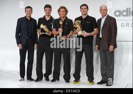 Herbert Hainer (L-R) executive chairman of the sportswear company adidas AG, German national soccer player Thomas Mueller, Uruguayan national soccer player Diego Forlan, Spanish national goalkeeper Iker Casillas and FIFA-representative Franz Beckenbauer stand next to each other during the award ceremony of the best players of the FIFA World Cup 2010 at the company headquarters of a Stock Photo