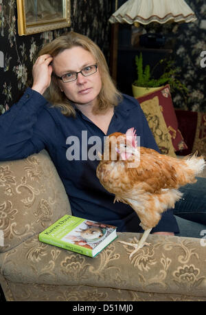 Author Karen Duve poses with chicken Rudi at her house in Ringenwalde ...