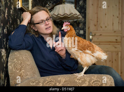 Author Karen Duve poses with chicken Rudi at her house in Ringenwalde ...