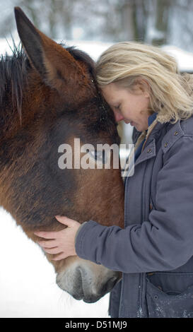 Author Karen Duve poses with chicken Rudi at her house in Ringenwalde ...