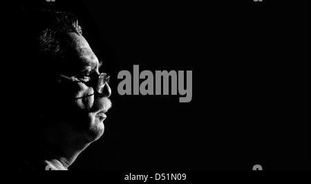 profile middle-aged man with glasses on black background Stock Photo