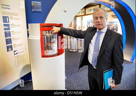 A file picture dated 16 November 2010 shows the director of RWE Gerd Jaeger with the model of a nuclear waste container at the information center of the nuclear power plant in Lingen, Germany. Public discussion about nuclear power has been among the most important subjects of 2010 that were covered in press and politics. Hundreds of thousands demonstrated in Berlin, the nuclear was Stock Photo