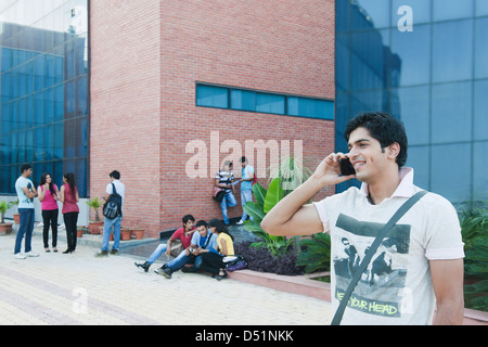 College student talking on a mobile phone and smiling Stock Photo