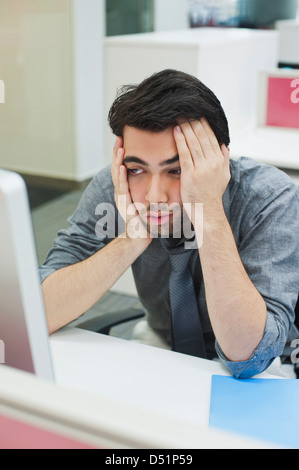 Businessman looking at a computer Stock Photo