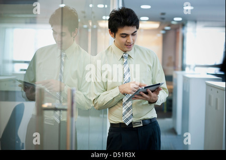 Businessman using a digital tablet and smiling Stock Photo