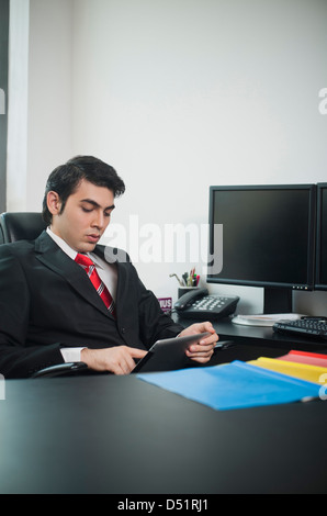 Businessman using a digital tablet in office Stock Photo