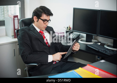 Businessman using a digital tablet in office Stock Photo
