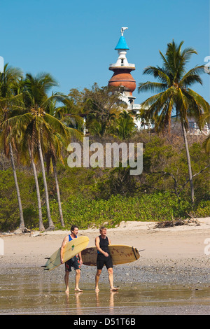 Longboard surfers on popular Playa Guiones beach, Nosara, Nicoya Peninsula, Guanacaste Province, Costa Rica, Central America Stock Photo