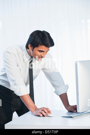 Businessman working on a desktop pc Stock Photo