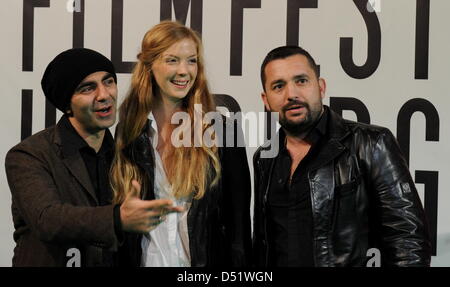 (L-R) German-Turkish filmmaker Fatih Akin, actress Pheline Roggan and boxing promoter Ahmet Omer smile at the opening of 18th Filmfest Hamburg in Hamburg, Germany, 30 September 2010. The film festival runs from 30 September to 09 October. Photo: Angelika Warmuth Stock Photo