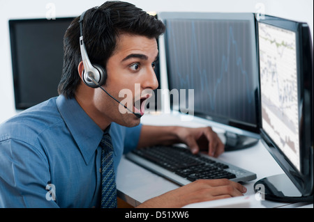 Surprised businessman looking at a computer Stock Photo