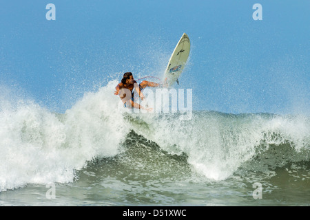 Surfer on shortboard riding wave at popular Playa Guiones surf beach, Nosara, Guanacaste Province, Nicoya Penninsula, Costa Rica Stock Photo