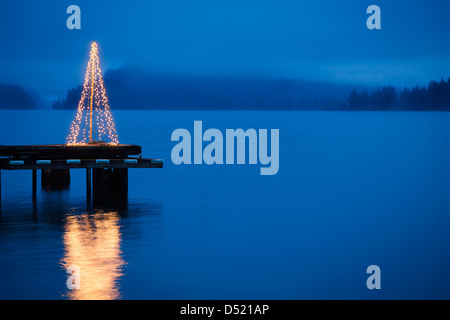 String of lights in tree shape on wooden pier Stock Photo