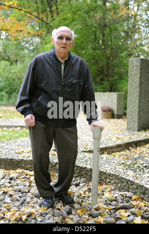 Siegfried Ebeling, a survivor of the mining drama of Lengede, poses knocking at the locked rescue shaft of the 'Mathilde' mine at the memorial in Lengede, Germany, 12 October 2010. The 79 year-old was one of eleven miners that were trapped in an abandoned shaft for 14 days, before they were rescued on 3 November 1963. The rescue operation became widely know as the 'Miracle of Lenge Stock Photo