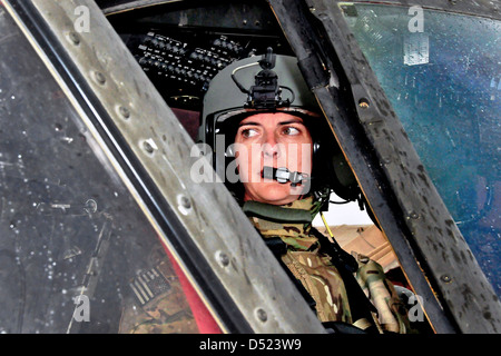 US Army Chief Warrant Officer Bethany Bump conducts her pre-flight check in a UH-60 Black Hawk helicopter before a mission March 13, 2013 at Jalalabad Airfield in Afghanistan's Nangarhar province. Stock Photo