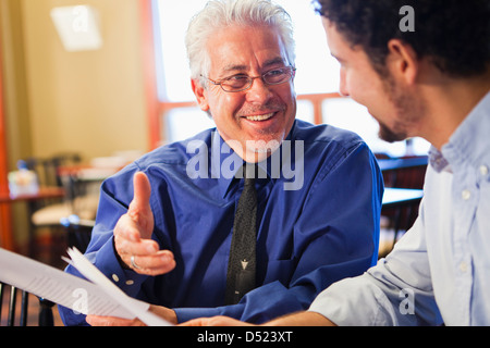 Businessmen talking in cafe Stock Photo