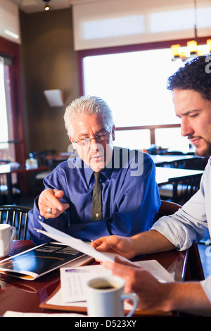 Businessmen talking in cafe Stock Photo