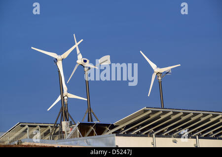 Wind turbines stand tall on rooftops of residential buildings between sets of solar panels in Freiburg, Germany, 7 March 2013. Photo: Patrick Seeger Stock Photo