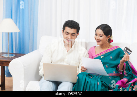 Couple doing online shopping with a laptop Stock Photo