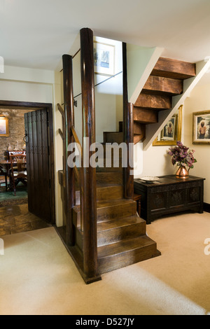 An arts and crafts style staircase in a cottage entrance hall. Stock Photo