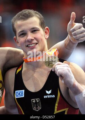 German gymnast Fabian Hambuechen cheers and holds his medal during the award ceremony where he was awarded with the bronze medal for the men's high bar final at the Artistic Gymnastics World Championships in Rotterdam, Netherlands, 24 October 2010. Photo: Marijan Murat Stock Photo