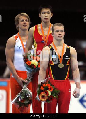 German gymnast Fabian Hambuechen (bronze) (R-L), Zhang Chengling from China (Gold) and Epke Zonderland from the Netherlands attend the award ceremony for the men's high bar final at the Artistic Gymnastics World Championships in Rotterdam, Netherlands, 24 October 2010. Photo: Marijan Murat Stock Photo