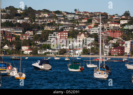 Waterfront apartment buildings and houses with moored pleasure boats at Rose Bay Eastern Suburbs Sydney Australia Stock Photo