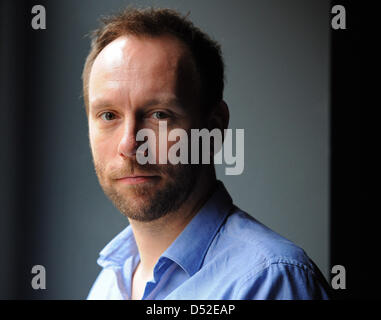 Norwegian director Alexander Mork-Eidem smiles for the photographer on the sidelines of a dress rehearsal of his staging of  Georg Friedrich Haendel's 'Orlando ...' in Berlin, Germany, 23 February 2010. His adaption will premiere at Berlin's 'Komische Oper' on 26 February 2010 and is set to be staged until July 2010. Photo: JENS KALAENE Stock Photo