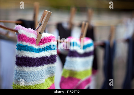 Colourful woolly socks pegged on to washing line Stock Photo