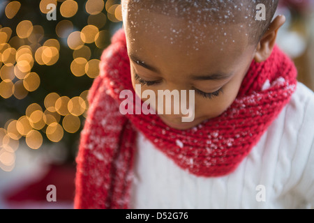 African American boy wearing scarf in snow Stock Photo
