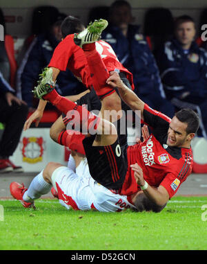 Leverkusen's Renato Augusto (top) and Arturo Vidal (C) fight for the ball with Cologne's Lukas Podolski (bottom) after the Bundesliga match Bayer 04 Leverkusen vs 1. FC Cologne at BayArena stadium in Leverkusen, Germany, 27 February 2010. The match ended in a goalless draw. Photo: Julian Stratenschulte Stock Photo