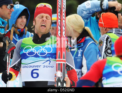 Axel Teichmann of Germany reacts after crossing the finish line the men's 50km Mass Start Cross Country Skiing event at the Vancouver 2010 Olympic Games, Whistler, Canada, 28 February 2010. Teichmann won silver. Photo: Peter Kneffel  +++(c) dpa - Bildfunk+++ Stock Photo