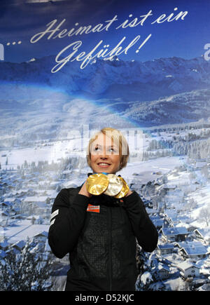German biathlete Magdalena Neuner attends a press conference and presents her medals during the reception in her home town Wallgau, Germany, 05 March 2010. Neuner won two gold medals and one silver medal at the Olympic Winter Games 2010 in Vancouver, Canada and is expected on a specially built stage on the town square in the late afternoon. Photo: TOBIAS HASE Stock Photo