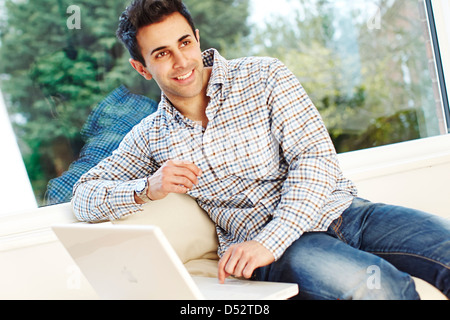 Man relaxing using laptop Stock Photo