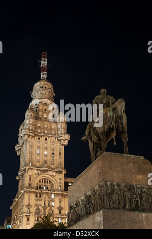 Public statue of General Artigas and towering skyscraper in Montevideo at night Stock Photo