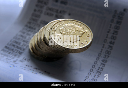 BRITISH ONE POUND COINS WITH SUPERMARKET TILL RECEIPT RE FOOD PRICES RISING THE ECONOMY HOUSEHOLD BUDGETS SPENDING INCOMES UK Stock Photo