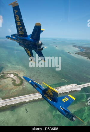 The US Navy flight demonstration squadron known as the Blue Angels fly in formation over the Florida Keys during a practice flight demonstration March 21, 2013 in Key West, Florida. Due to the budget Sequester the Blue Angels will stop flying on April 1, 2013. Stock Photo