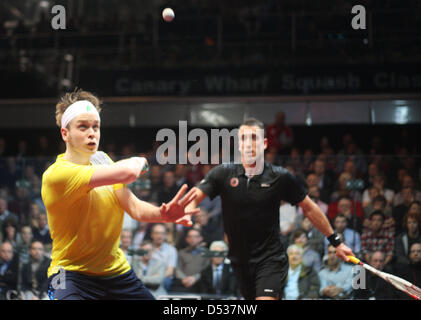 London, UK. 22nd March 2013.  James Willstrop (yellow Shirt England) (2) against Peter Barker (black Shirt England) (4) in action during the Canary Wharf Squash Classic final at the East Wintergarden Canary Wharf. Credit:  Action Plus Sports Images / Alamy Live News Stock Photo