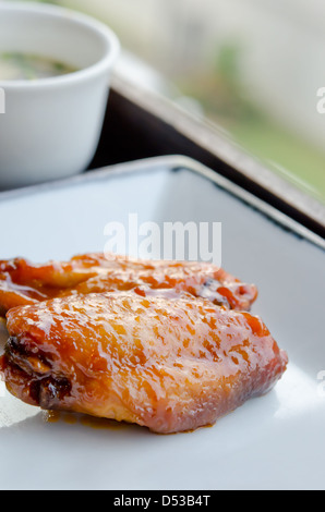 Fried Chicken Wings with sweet sauce on dish Stock Photo