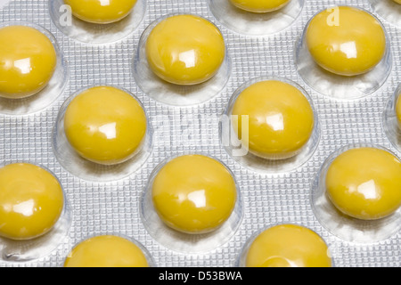 Yellow pills isolated on white background Stock Photo