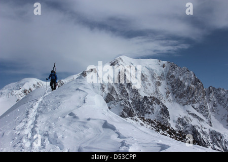 Ski touring ridge of Domes de Miage. Summit of Mont Blanc in background. Stock Photo