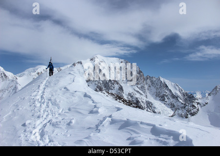 Ski tour ridge of Domes de Miage. Summit of Mont Blanc in background. Stock Photo