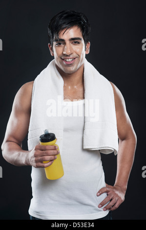 Portrait of a man holding a water bottle and smiling Stock Photo