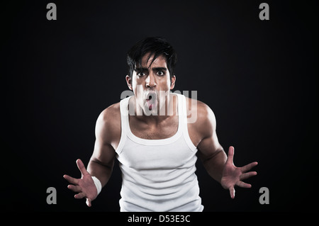 Portrait of a man shouting and looking shocked Stock Photo