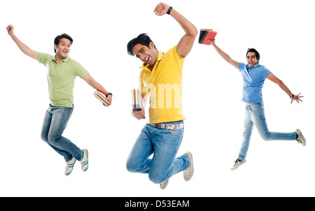 University student holding books and jumping Stock Photo