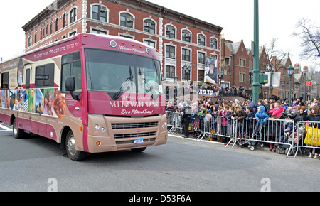 Mitzvah Tanks parading past Lubavitch headquarter to celebrate the birthday of the Lubavitcher Rebbe Menachem Mendel Schneerson. Stock Photo